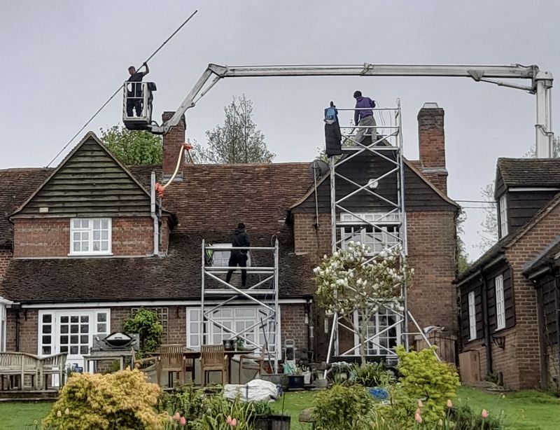 The Roof Moss Cleaners using cherry picker and scaffolding to clean roof safely and professionally in Bursledon, Hampshire